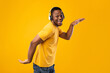 © Prostock-studio - Black Male Listening Music Wearing Headphones Dancing Over Yellow Background