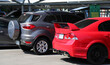 canvas print picture - Closeup of red sedan car parking in outdoor  parking area in bright sunny day. 