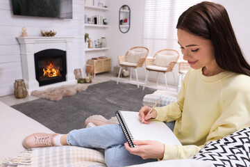 Poster - Young woman drawing in sketchbook at home, space for text