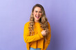 © luismolinero - Young Brazilian woman isolated on purple background celebrating a victory