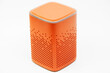 © Григорий Юник - portable orange speaker on white background.the concept of listening to music. wireless audio playback device. color subwoofer
