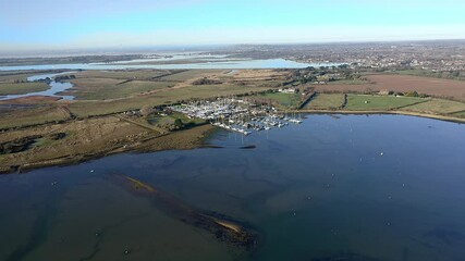 Poster - Approaching Thornham Marina over Prinstead Estuary Channel on the Southern Coast of England, Aerial video.