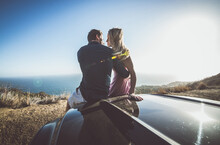 Romantic Moment On The Cliff In Malibu. Couple Watching Panorama From Their Car