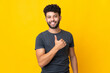 © luismolinero - Young Moroccan man isolated on yellow background giving a thumbs up gesture