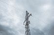 © Daniil - Tall tower of power lines on background of gray cloudy sky. High electric tower with wires against cloudy gray sky. Tower of electricity in overcast. Сloudscape with power lines against gray clouds.