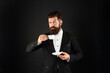 © be free - man in tuxedo bow tie with coffee cup. gentleman in formalwear drink coffee on black background