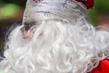 Santa Claus with a white beard and glasses