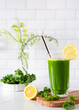 Healthy and refreshing homemade green vegetable juice made from kale and lemon; copy space