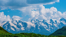 Idyllic Landscape With Blue Sky, Green Grassland And Snowcapped Mountain Top. Svanetia Region, Georgia