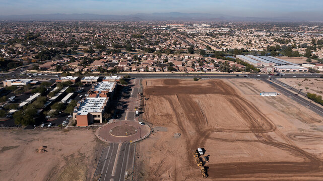 Parts of the downtown urban core next to empty construction plots in Surprise, Arizona, USA.