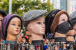Mannequins wearing hats on the sidewalk in Harlem.