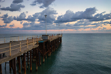 Canvas Print - Seascape with sunset view and pier. New Athos