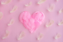 Heart Shape Made Of Pink Feathers, Fuzz, Fluff On Pink Background. Pattern Of White Feathers. Love Heart, Valentine, Romantic Background/ Valentines Day Concept