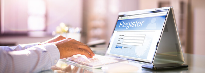 Businessman's Hand Filing Online Registration Form