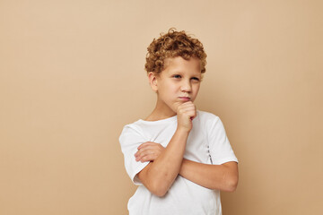 Cute little boy in a white t-shirt posing fun Lifestyle unaltered