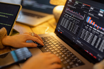 woman working on some programming dashboard on laptop, close-up on hands and keyboard. programmer, s