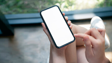 Wall Mural - closeup female hands using smartphone at home. blank screen mobile phone for graphic display montage