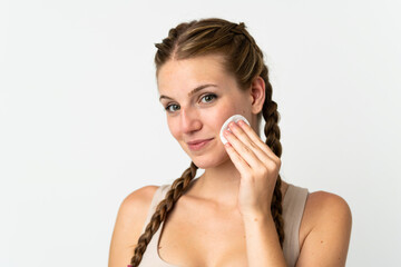 Wall Mural - Young caucasian woman isolated on white background with cotton pad for removing makeup from her face