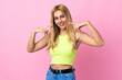 © luismolinero - Young Uruguayan blonde woman over isolated pink background giving a thumbs up gesture