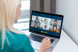 © Angelov - Cropped image of young woman using laptop for video conference at home