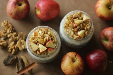 overnight oats with apple and almonds. made by soaking rolled oats and chia seeds in milk served wit