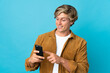 © luismolinero - English man over isolated blue background sending a message or email with the mobile
