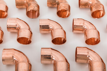 Group of fittings on a white background. Copper fittings for pipe connections. Technical basis for heating companies.