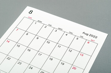 August 2022 calendar sheet on grey background.