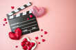 canvas print picture - Happy Valentines day and romantic movie concept with  movie clapper board, heart shapes and chocolates on pink background. Flat lay, top view