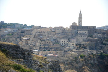 Poster - ITALY-Matera is a city located on a rocky outcrop in Basilicata, in Southern Italy. It includes the Sassi area, a complex of Cave Houses carved into the mountain