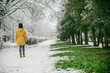 woman walk by park where winter meet spring