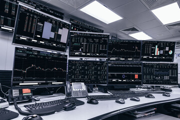 Display of Stock market quotes and chart in monitor computer room with business office equipments .business and money concept, panorama photo