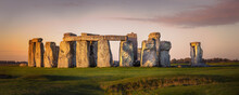 Panorama Of The Prehistoric Site Of Stonehenge During Early Morning. Beautiful Orange Glow On The Stones