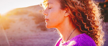 Close Up Sunset Portrait Of Attractive Woman With Closed Eyes And Sun In Back Light. Dreaming And Enjoying Feeling Concept Lifestyle Emotion. Serene Female People Outdoor With Curly Hair