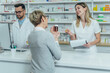 © Zamrznuti tonovi - Pharmacist giving prescription medications to smiling senior female customer