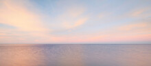 Baltic Sea Under The Colorful Sunset Sky. Stunning Seascape. Golden Sunset Light Through The Pink Clouds. Long Exposure. Tranquility Scene. Riga Bay, Latvia