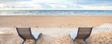 An Empty Modern Wooden Promenade Through The Sandy Shore Of The Baltic Sea, Sun Lounger Close-up. Sport, Recreation, Cycling, Nordic Walking, Relaxation, Vacations, Weekend, Tourism, Leisure Activity
