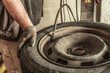 Close up view of a mechanic inflating a tyre with an automatic tool