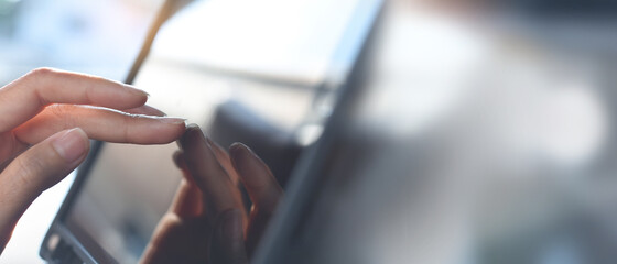 Wall Mural - Close up, woman hand using digital tablet and finger touching on the screen to search online content