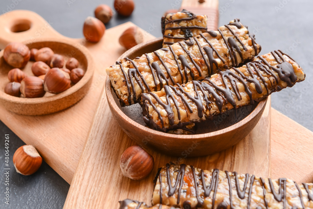 Plate with tasty chocolate nut bars on table