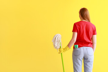 Wall Mural - Young woman with sponge and floor mop on color background