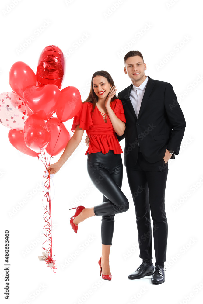Happy young couple with balloons on white background. Valentine's Day celebration
