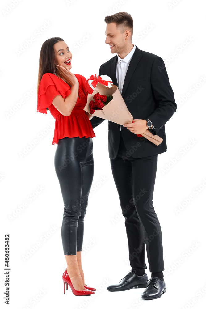 Young man greeting his girlfriend for Valentine's Day on white background
