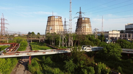 Aerial drone view flight near thermal power plant. Cooling towers of CHP thermoelectric power station. View of the power plant and cooling towers. Cooling towers of a thermoelectric power station