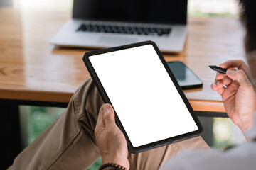Close up view of man using tablet blank white screen for text message or information.