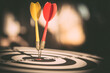 © Jintana - Bullseye target goal or dartboard has dart arrow throw hitting center shooting for financial business targeting planning to winner concept.