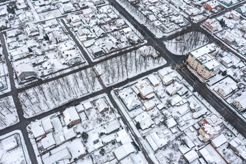 Wall Mural - winter cityscape. suburb residential area covered with snow. top view aerial photo from flying drone.