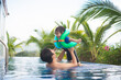 © lalalululala - Asian father and son  having fun together in swimming pool
