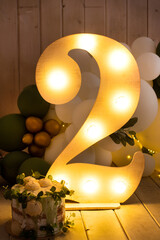 figure two with orange lamps. balloons, deuce, cake. holiday decoration. Illuminated bulb number 2