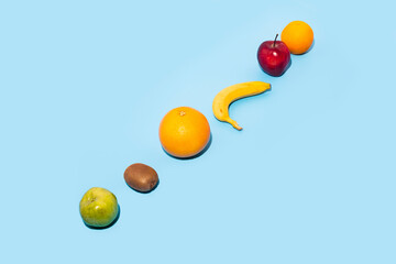 Wall Mural - Fresh fruits on a blue background. Top view, flat lay.